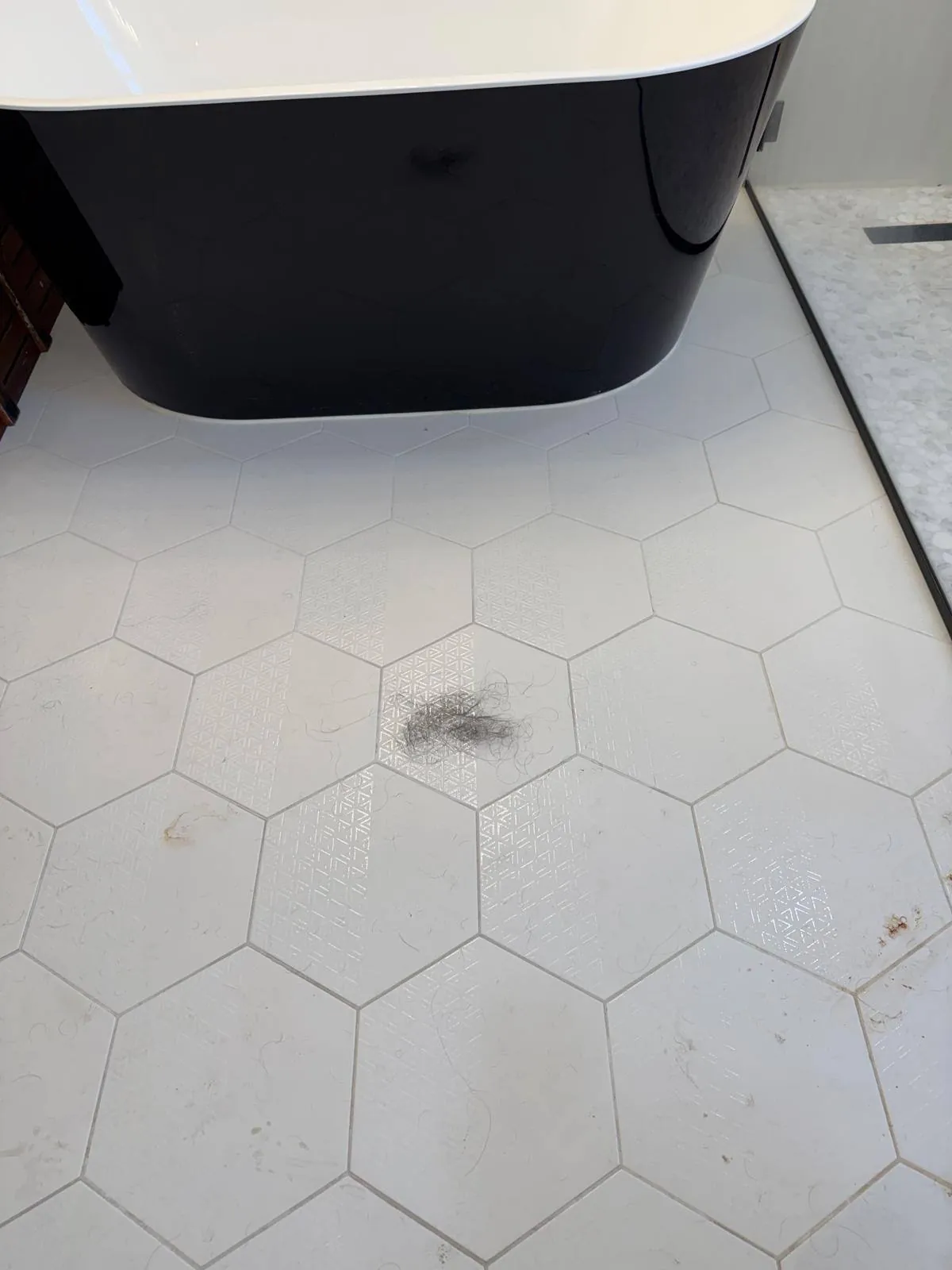Bathroom hex tile floor before cleaning