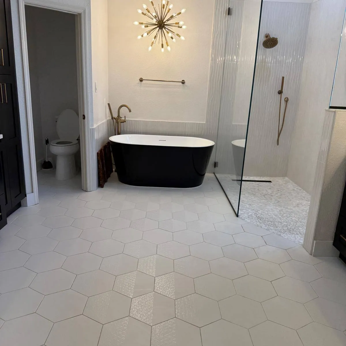 Master bathroom after a deep clean: freestanding tub and hex tile floor