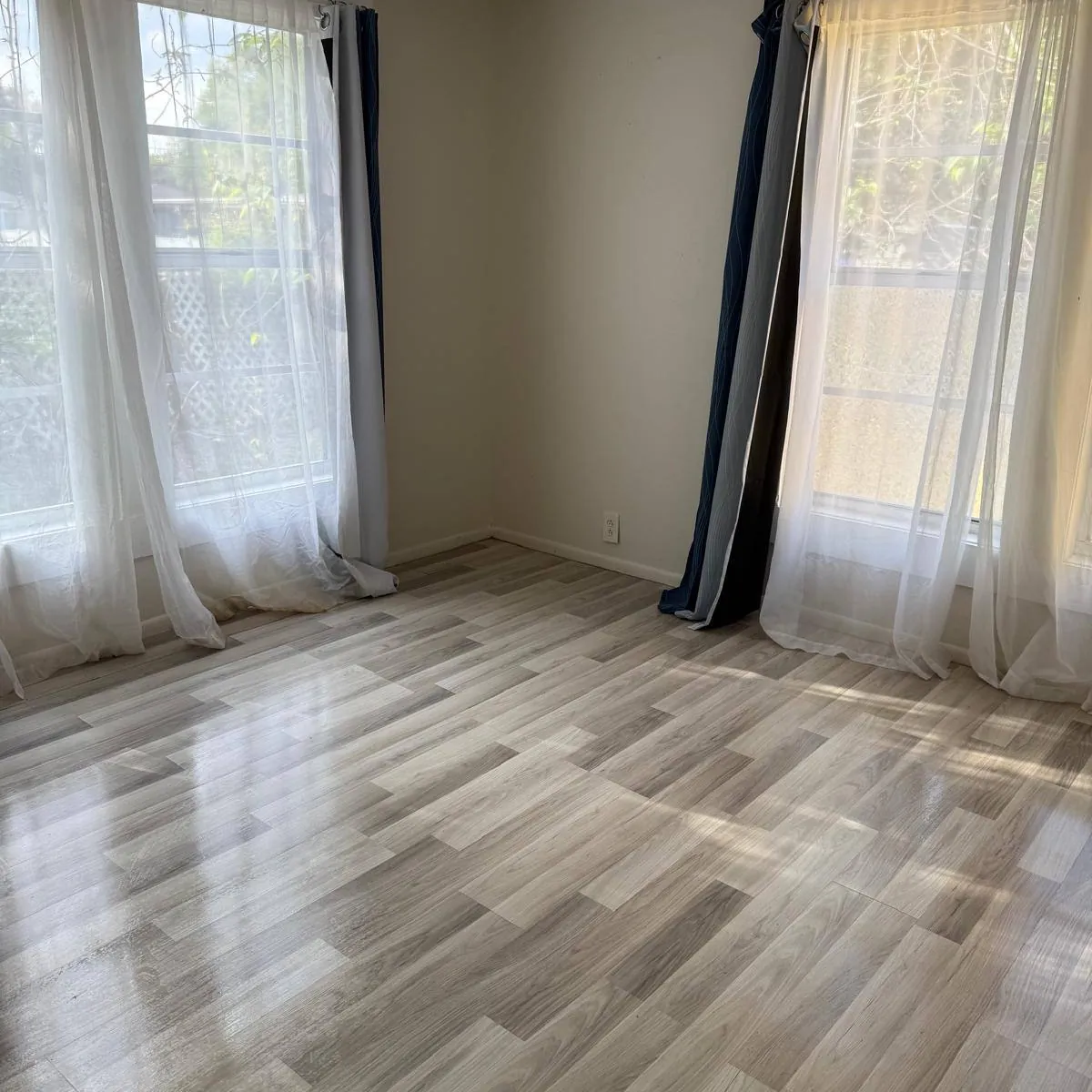 Empty room after a move-out clean, floors polished